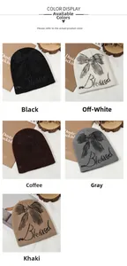 Close-up of knit beanies in multiple colors featuring a bow design and Blessed lettering