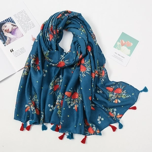 Close-up of blue floral scarf with strawberry prints and soft red tassel details