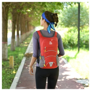 Outdoor red lightweight hiking backpack showing back view in use with breathable mesh