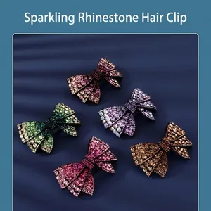 Sparkling rhinestone bow hair clips in multiple colors on a blue textured background