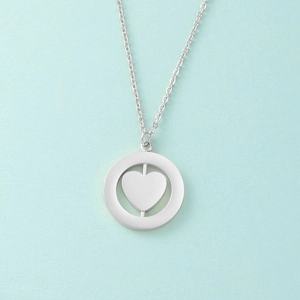 Detail of silver rotating heart pendant necklace with double layer circular geometry