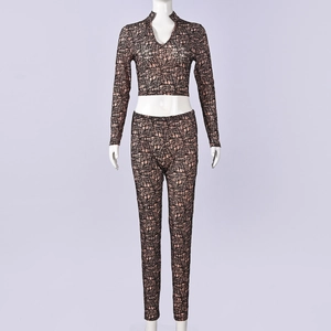 Detail of pink-brown crop top and slim pants with black irregular grid pattern