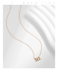 Detailed view of the gold S925 silver necklace featuring a unique crown pendant and gemstone