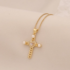 Elegant gold stainless steel cross necklace with heart crystal and white pearl accents