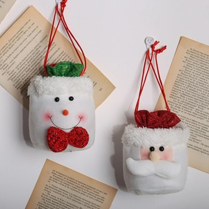 Hanging Christmas burlap gift bags featuring plush Santa Claus and snowman designs