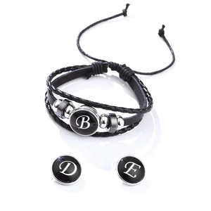 Black braided leather bracelet with interchangeable silver-tone letter charms B D and E