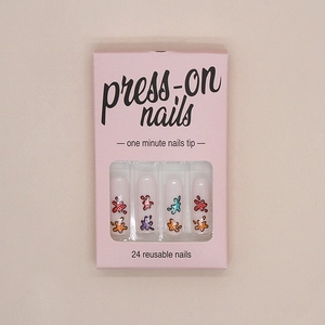 Detail view of colorful splash graffiti press-on nail kit in pink packaging with 24 pieces