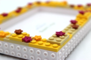 Close-up detail of a DIY star theme building block photo frame with white and yellow bricks