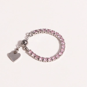 Close-up of pink zircon tennis bracelet with heart pendant and adjustable sliding clasp