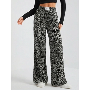 Detail of high waisted wide leg leopard print trousers with elastic waistband and woven label