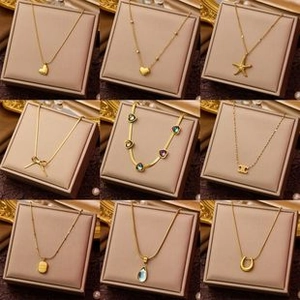 Collection of titanium steel necklaces with various elegant gold plated pendants