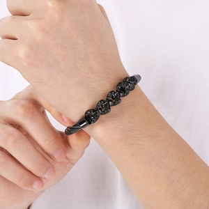 Punk style black stainless steel skull bracelet for men featuring durable wire rope design