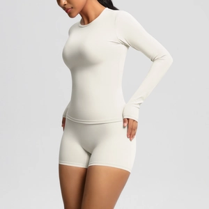 Detail of skin-friendly brushed yoga set featuring tight long sleeves and high waist shorts
