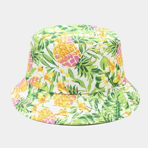 Detailed close-up of a double-sided bucket hat with vibrant lemon and tropical leaf patterns