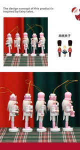 Detail of five-piece pink and white nutcracker soldier ornaments with golden hanging strings
