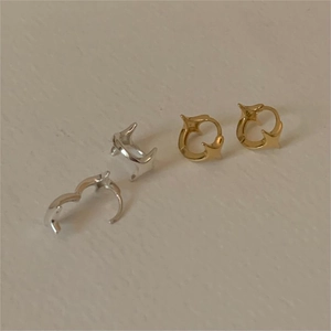 Close-up of heart-shaped S925 sterling silver hoop earrings in gold and silver finish