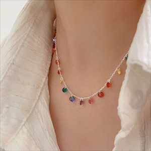 Macro detail of 925 sterling silver chain necklace with multicolored zircon stones