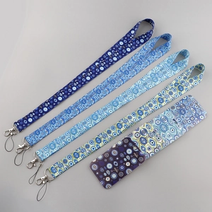 Macro shot of evil eye patterned lanyards and matching ID card holder with lobster clasps