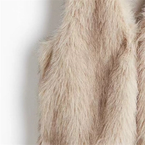 Close-up of fluffy faux fur texture in beige showing the premium long-pile material detail