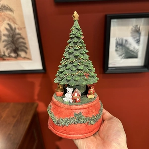 Classic green Christmas tree music box with festive polar bear and golden star on top