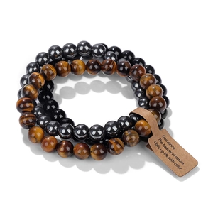 Detail of three-layer beaded bracelets with natural tiger eye and hematite gemstones