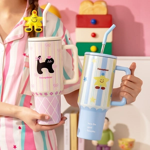 Close-up of high-capacity striped mugs with handles and straws featuring cat and star designs