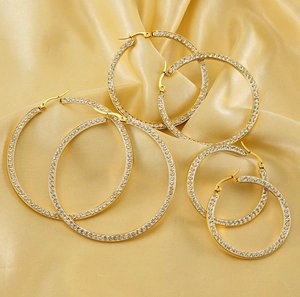Detailed view of three pairs of 18k gold plated stainless steel crystal hoop earrings