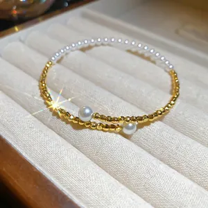 Elegant gold beaded bracelet with pearls in a velvet jewelry box display