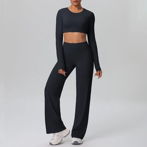 Detail of black long sleeve crop top and high-waist wide-leg yoga pants set