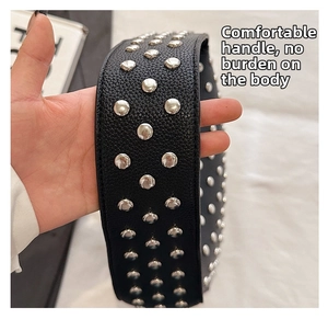 Close-up of black lychee texture leather strap with silver metal round studs detailing