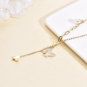 Minimalist gold titanium necklace featuring butterfly shell pendants and pearl drop detail