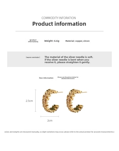 Detailed view of 18k gold plated C-shaped earrings with micro-paved cubic zirconia