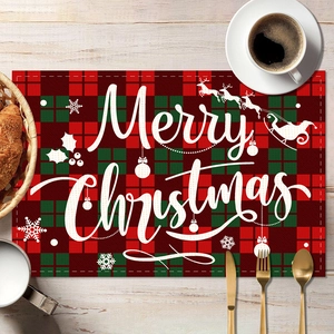 Close-up of Merry Christmas plaid placemat with rustic wood background and gold cutlery