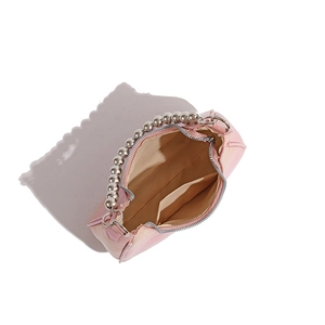 Detail of pink crescent bag with silver beaded handle and interior pocket layout