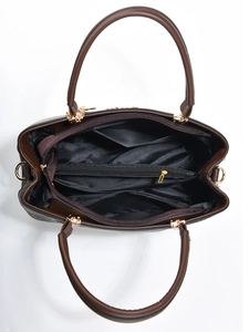 Top view of brown handbag interior showing multiple compartments and zip pocket
