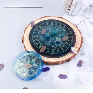 Macro shot of Viking compass resin mold kits with blue teal glitter finish on wood