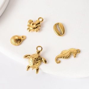 Gold stainless steel ocean pendants featuring crab, shell, turtle, and seahorse for DIY jewelry