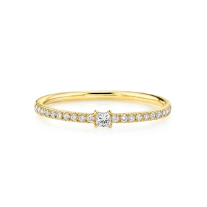 Macro shot of gold-plated silver ring with square center stone and half-eternity diamond band