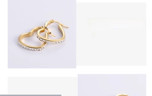 Detail of heart-shaped gold earrings featuring a row of sparkling embedded crystals