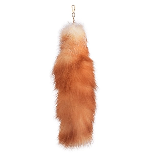 Plush red-brown fox tail keychain with golden metal chain on a white background