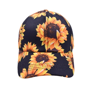 Classic black baseball cap featuring vibrant yellow sunflower prints and curved brim