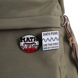 Math puns enamel pin badges on green canvas bag showing science and geometry designs