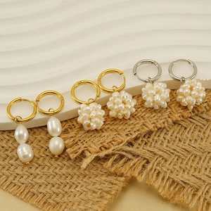 Three pairs of 18k gold plated stainless steel natural pearl earrings set on white display