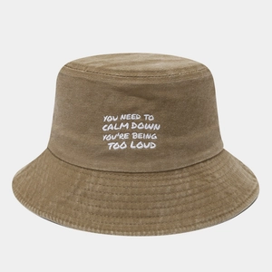 Detail of washed khaki canvas bucket hat with white embroidered text on the front