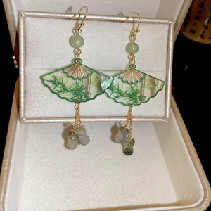 Modern Chinese style green fan earrings with bamboo pattern and jade-like beads in a jewelry box