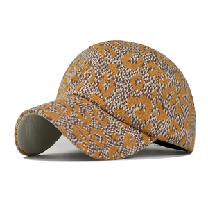 Close-up of thick knit baseball cap featuring a brown leopard print pattern and gray brim