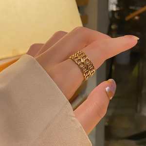 Detailed view of an 18k gold-plated stainless steel chain link ring on a finger