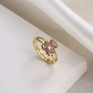 Detailed macro view of a gold-plated bear ring with a sparkling pink heart cubic zirconia