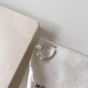 Elegant S925 sterling silver open ring with delicate white pearls in a minimalist design.