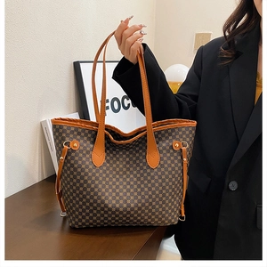 Detail of vintage brown tote bag with geometric print and decorative side drawstrings